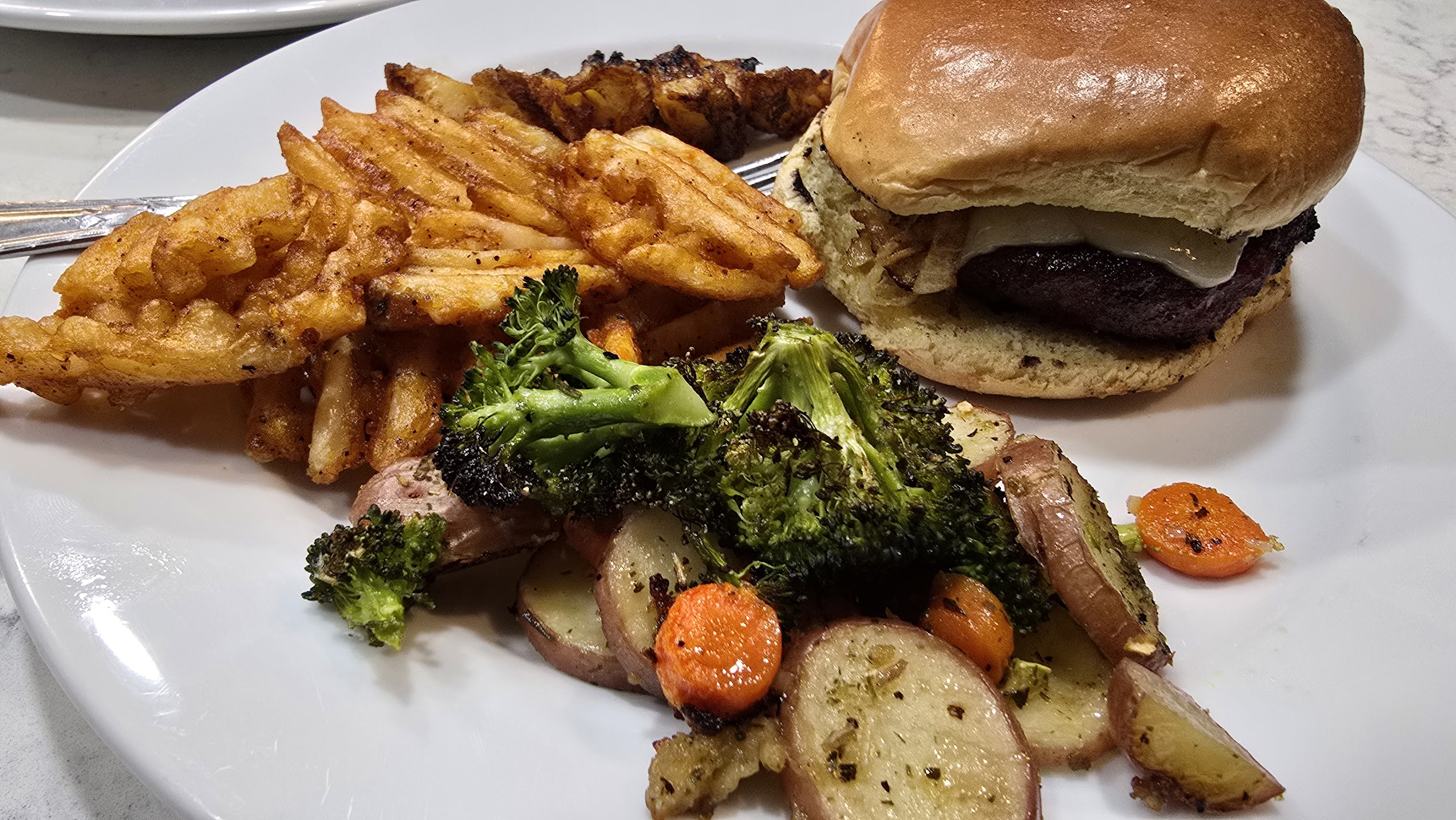 Burger with fries and potatoes